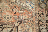Distressed vintage Heriz rug with geometric arrowed blossoms and chocolate Turtle Samovar border.