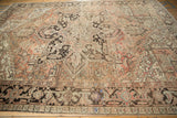 Distressed Heriz carpet corner with a dusty rose, brown, and beige Turtle Samovar border.