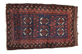 Antique Belouch mat with double column medallions in madder red and ivory on a rich cobalt blue field.