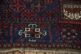 Detail showing the worn corner and tattered fringe of an antique Persian Belouch rug.