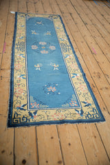 Corner of antique Peking runner: sky blue field, saffron border with lotus, geometric pattern, tattered.