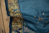 Textured pile of an Antique Peking runner, sky blue field, saffron border with navy scrolling vines.