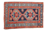 Antique Northwest Persian rug with geometric serrated medallions, cobalt blue and tomato red.