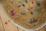 Plush hand-knotted pile showing colorful scrolling vines and blossoms on a saffron yellow field.