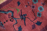 Pictorial bird and floral vine on antique Art Deco runner, cochineal red pile with exposed foundation.