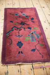 Antique Chinese Art Deco pictorial rug detail: bird on branch, cochineal red, sapphire blue pile.