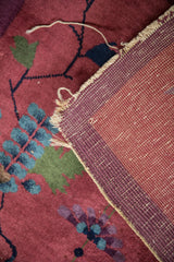 Antique Art Deco rug's hand-knotted foundation with cochineal red pile and tattered fringe.