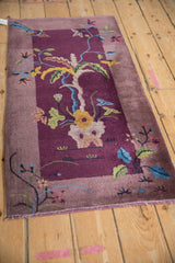 Aubergine and mauve field with intricate pictorial plant motif on an Art Deco rug runner.
