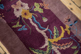 Textured pictorial plant design on an antique Art Deco rug in aubergine, gold, and celadon.