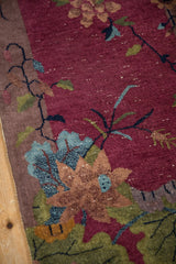 Art Deco Chinese runner detail: burgundy field, apricot lotus, blue grape-like leaves, white knots.