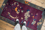 Art Deco rug, deep violet field, beige lotus flowers, slate gray border details.