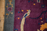Antique Art Deco rug detail: Pictorial bird in antique ivory, sapphire blue, on a violet field.