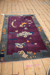 Antique Chinese Art Deco rug with deep violet pictorial field, bird, lotus, and slate blue border.