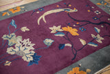 Detail of the antique Art Deco rug's slate blue border with pale orange blossoms.