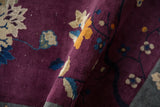 Deep violet pile and curvilinear lotus floral motifs on an antique Art Deco rug.