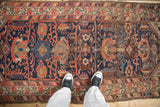 Antique Malayer runner detail featuring cobalt blue field, coral palmettes, and knot head wear.