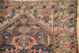 Visible foundation wear and intricate geometric patterns on antique Malayer rug runner.