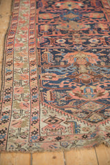 Antique Malayer rug runner field featuring geometric palmettes, cobalt, red, and visible wear.