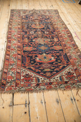 Worn geometric border and tattered fringe of an antique Malayer runner.