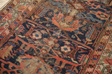Antique Malayer rug detail: cobalt field, geometric blossoms, and exposed foundation.