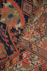 Antique Malayer rug runner with visible foundation, worn pile, and tattered red and blue edges.
