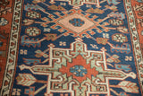 Karaja rug's geometric floral palmette and serrated leaf patterns in blue, red, ivory.