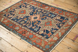 Vintage Karaja rug's madder root red border with serrated leaf, roundel blossoms, blue field.