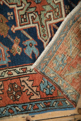 Vintage Karaja rug pile, cobalt blue and red geometric designs, revealing its hand-knotted foundation.