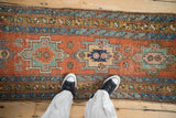 View from above showing the scale and texture of the runner's geometric medallion and colorful borders.