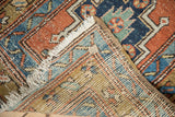 Folded corner of an antique Persian runner showing the hand-knotted foundation and geometric pile.