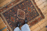 Fine weave and vibrant geometric diamond medallion of a vintage Karaja rug with a pawn motif.