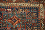 Geometric design and hook and latch relief in navy, teal, rust on a fine Karaja rug.