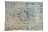 Distressed vintage Persian Mehrivan carpet, sapphire blue medallion, geometric patterns, muted ivory field.