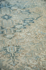 Distressed Mehrivan carpet pile with geometric ivory and blue patterns, foundation showing.
