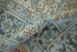 Distressed vintage Mehrivan carpet pile in soft blue, ivory, and coffee brown patterns.