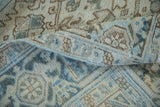 Distressed texture and geometric pattern in ivory, beige, and blue of a Mehrivan rug.