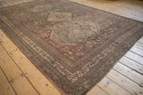 Distressed Persian Shiraz carpet border with geometric floral motifs in chestnut and ivory.