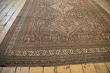 Distressed Persian Shiraz carpet border showing geometric patterns, time-softened tones, and fringe.