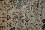 Close-up of distressed Kamseh carpet, highlighting worn pile, geometric patterns, faint foundation, cream, and dusty teal.