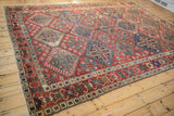 Bakhtiari carpet's crab stylized border, displaying red, sapphire blue, and blush motifs.