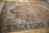 Traditional distressed Heriz border with serrated leaf motifs in chestnut, slate blue, and ivory.