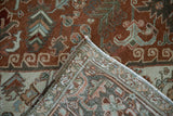 Vintage Distressed Heriz carpet corner revealing worn pile, woven back, and original side selvage.