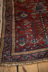 Antique Lilihan rug corner with cherry red field, palmettes, and unique camel-faded magenta borders.