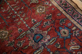 Cherry red antique Lilihan rug showing dusty teal palmettes and the faded magenta border.