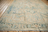 Distressed vintage Heriz rug with geometric blossoms in faded sapphire and dusty teal.