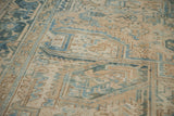 Distressed vintage Heriz rug detail showing faded blues, geometric patterns, and visible knot heads.