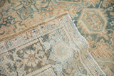 Distressed vintage Heriz rug showcasing worn pile, visible knot heads, and woven foundation.