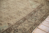 Persian Bijar carpet's distressed beige field with ocean blue accents and brown border.