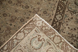 Corner of distressed vintage Bijar carpet revealing hand-knotted foundation and intact selvage.