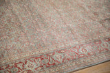 Distressed Tabriz carpet corner: cherry red Samovar Turtle border and Herati motif field.